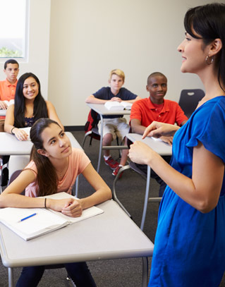 Teacher talking to students in a classroom