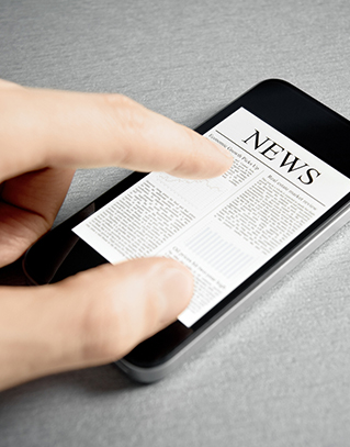 Adult hand viewing news on a mobile phone